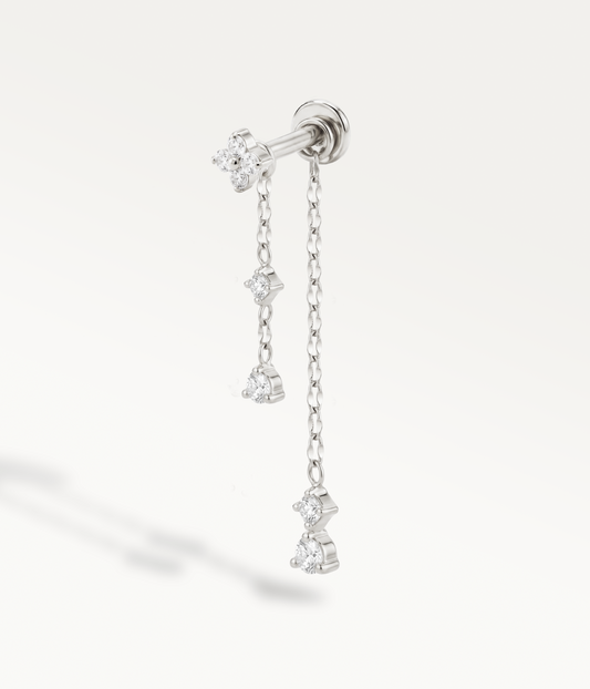 Silver-tone clover with two chains of different lengths ending in stones.
