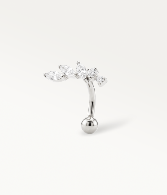 Silver-tone Orée Banane with an elongated stone design and curved post, three-quarter view.