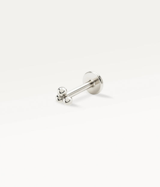 Silver-tone Annouk stud with three small beads and a flat back, side view.