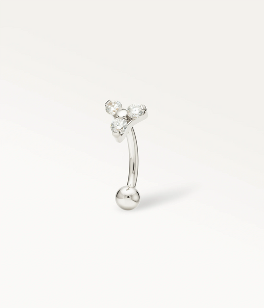 Silver-tone Triade Rook, three stones arranged in a triangle on a curved barbell, side view.