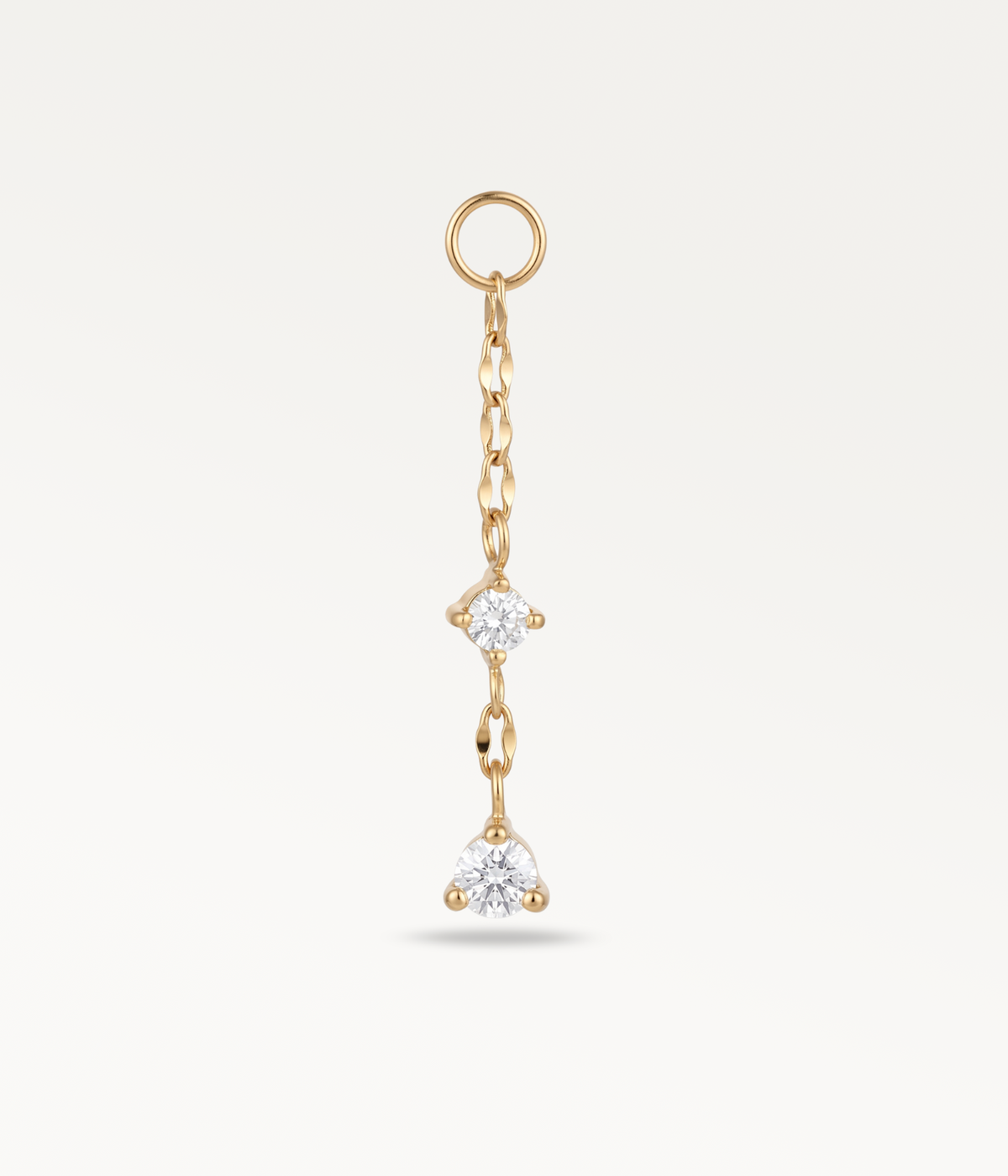 Chaîne Stella dorée avec une pierre intermédiaire et un pendentif serti à son extrémité.