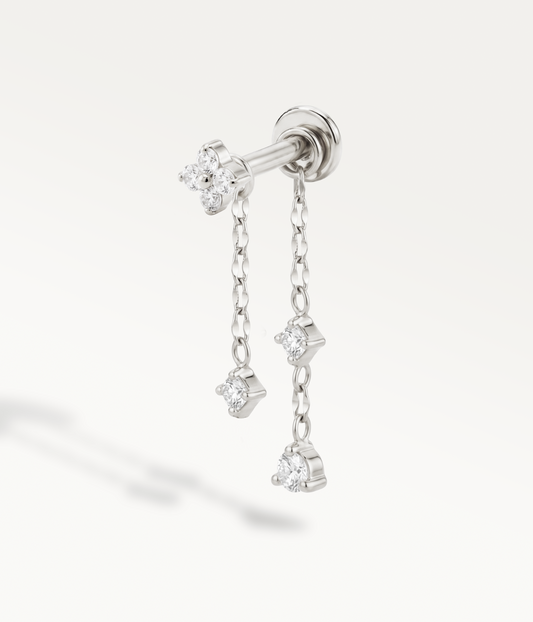 Silver-tone clover accompanied by Astrid and Stella chains with dangling stones.