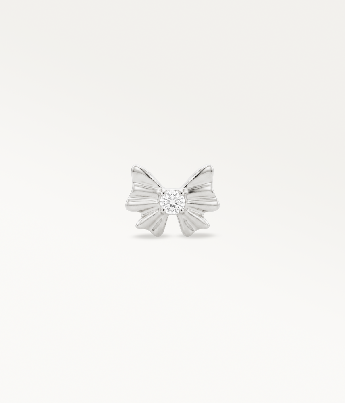 Silver-tone Noeud d’Or, tied ribbon design with a central stone, front view.