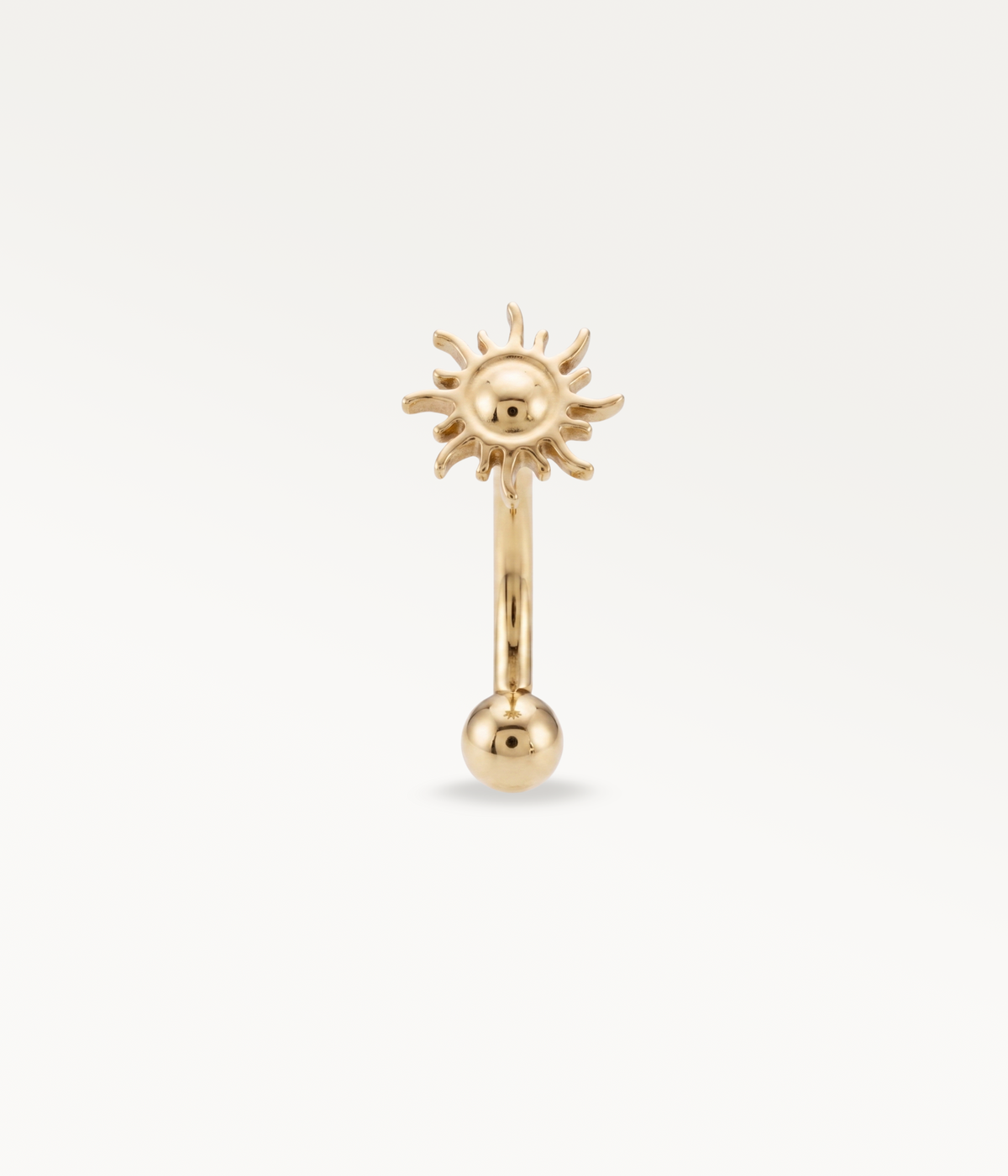 Gold-tone Helios Banane, front view of the sun and lower ball.