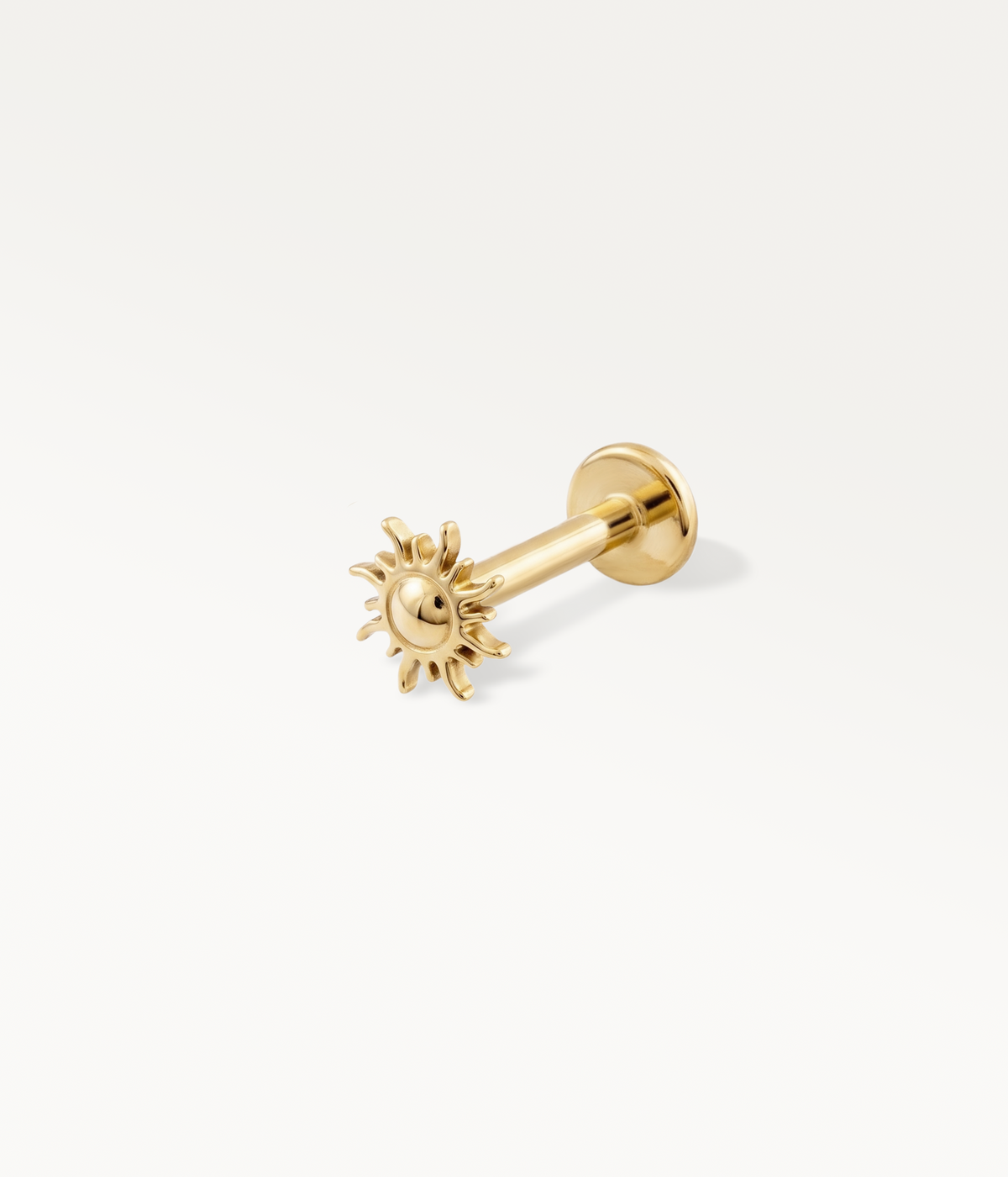 Gold-tone sun-shaped Helios stud, detail of the post and flat back.