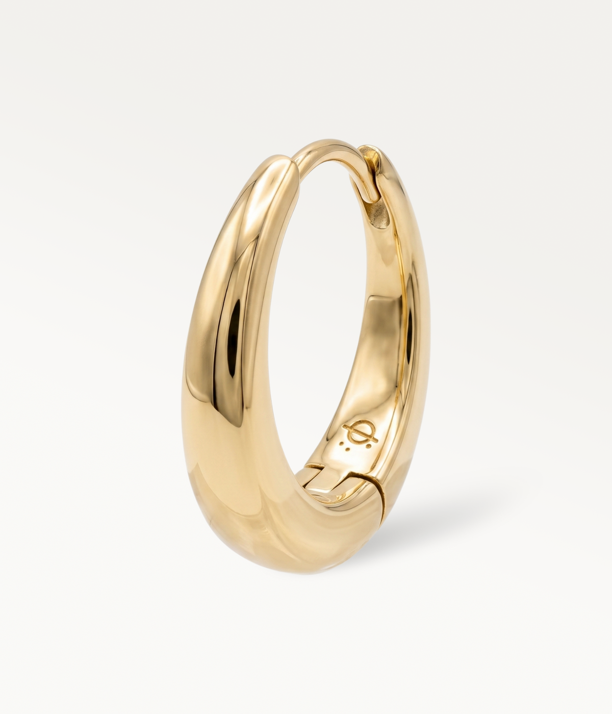 Large gold-tone Soline hoop earring, smooth, domed hoop, three-quarter view.