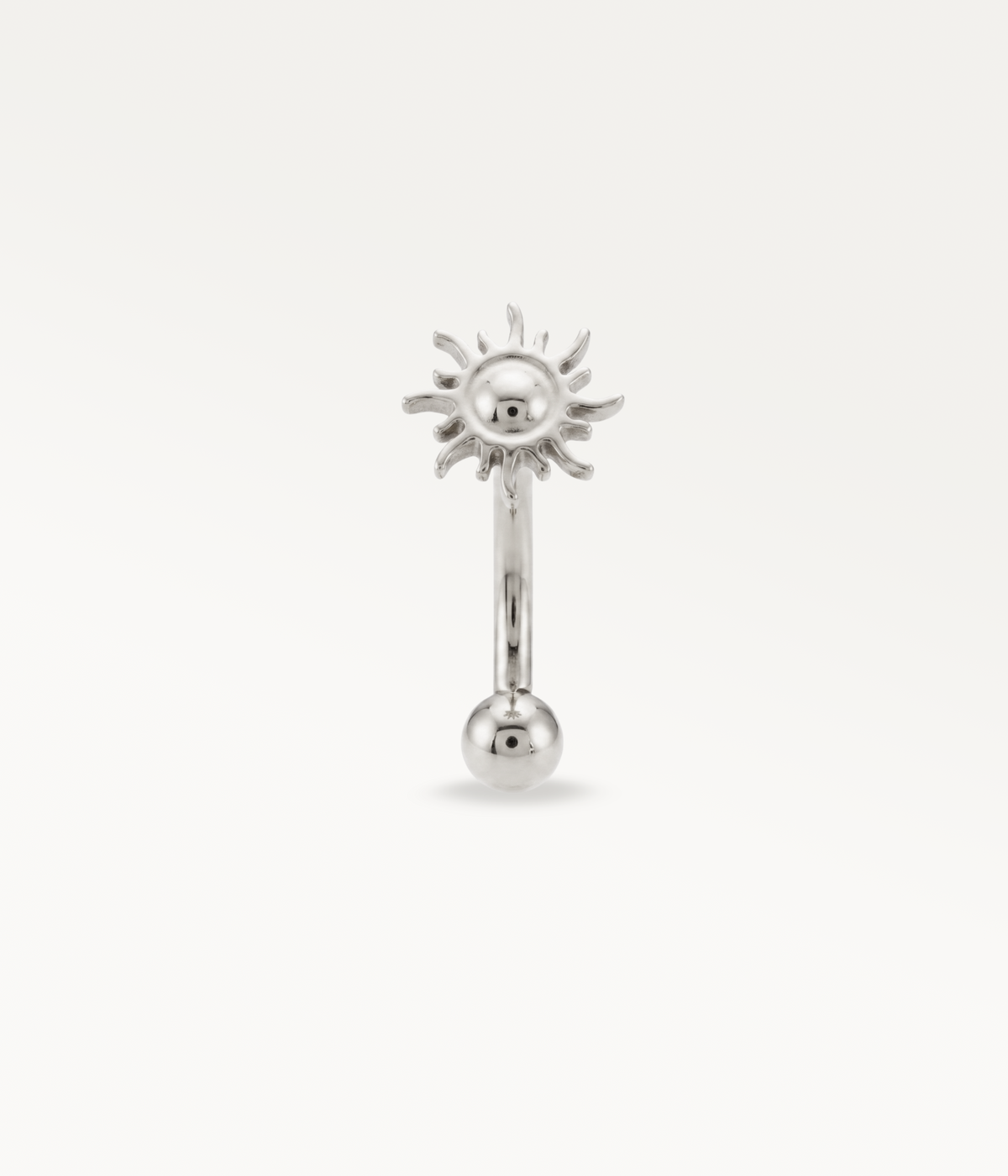 Silver-tone Helios Banane, front view of the sun and lower ball.