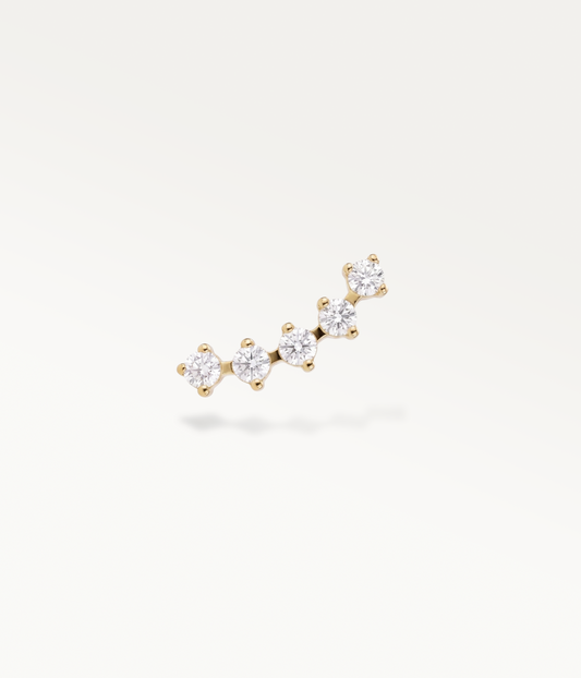 Sillage Lobe doré, ligne courbe de petites pierres rondes, vue de face.
