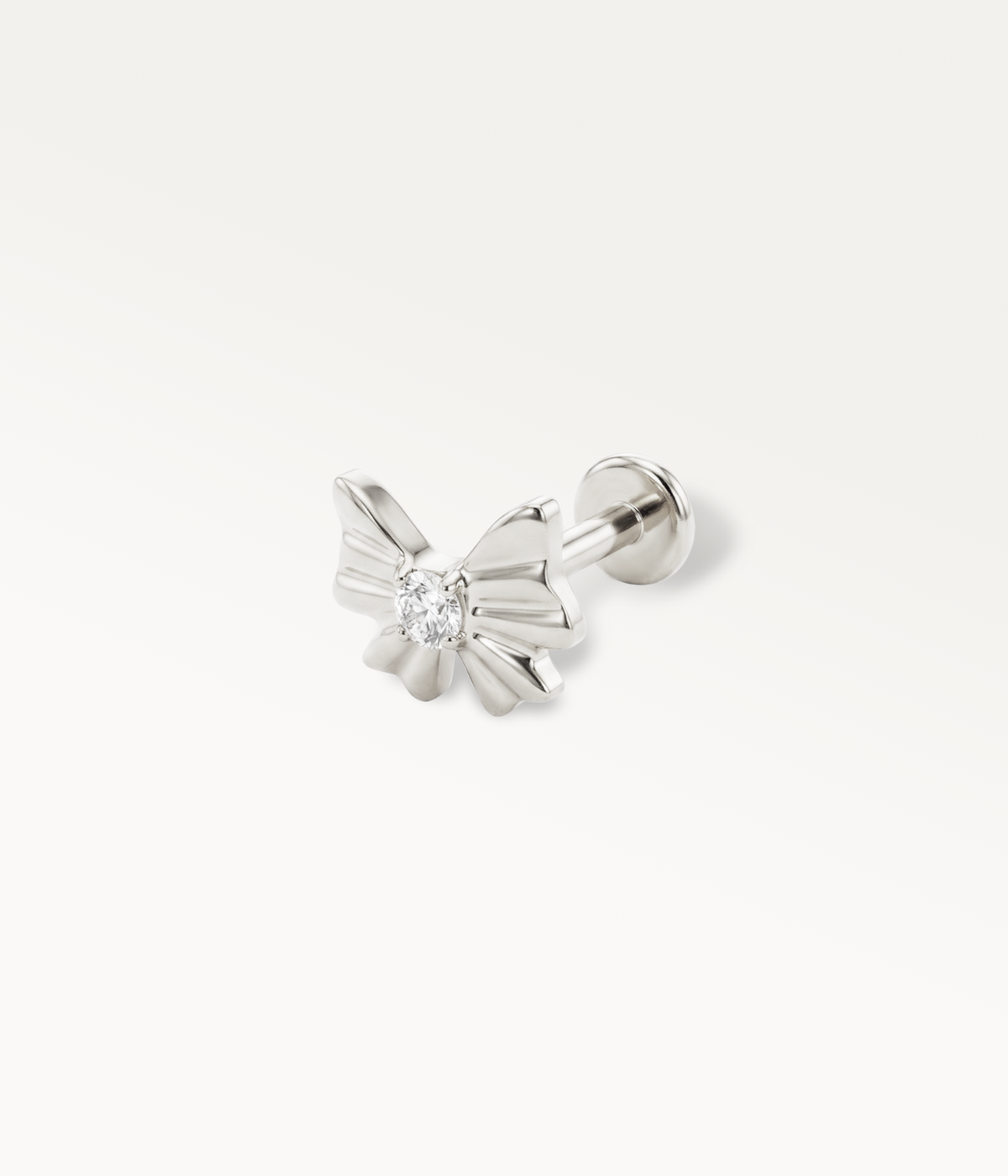 Silver-tone Noeud d’Or stud with a ribbon and central stone, detail of the flat-back post.