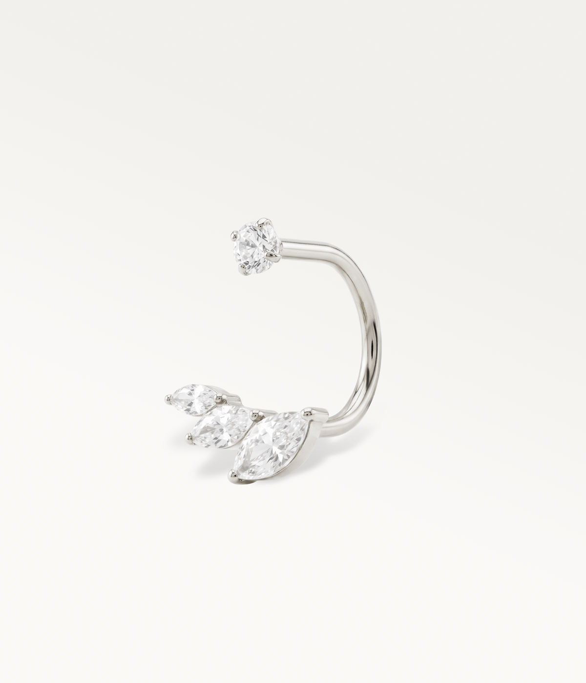 Silver-tone Eclat earring, an open hoop between a round stone and three marquise-shaped stones.