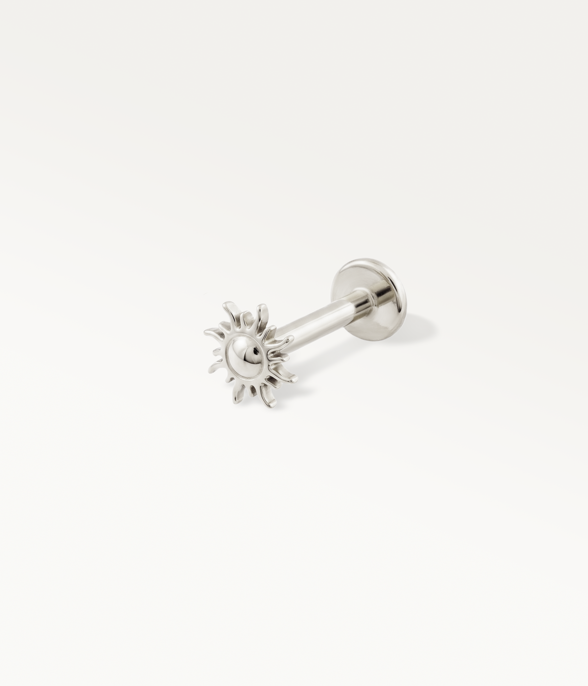 Silver-tone sun-shaped Helios stud, detail of the post and flat back.