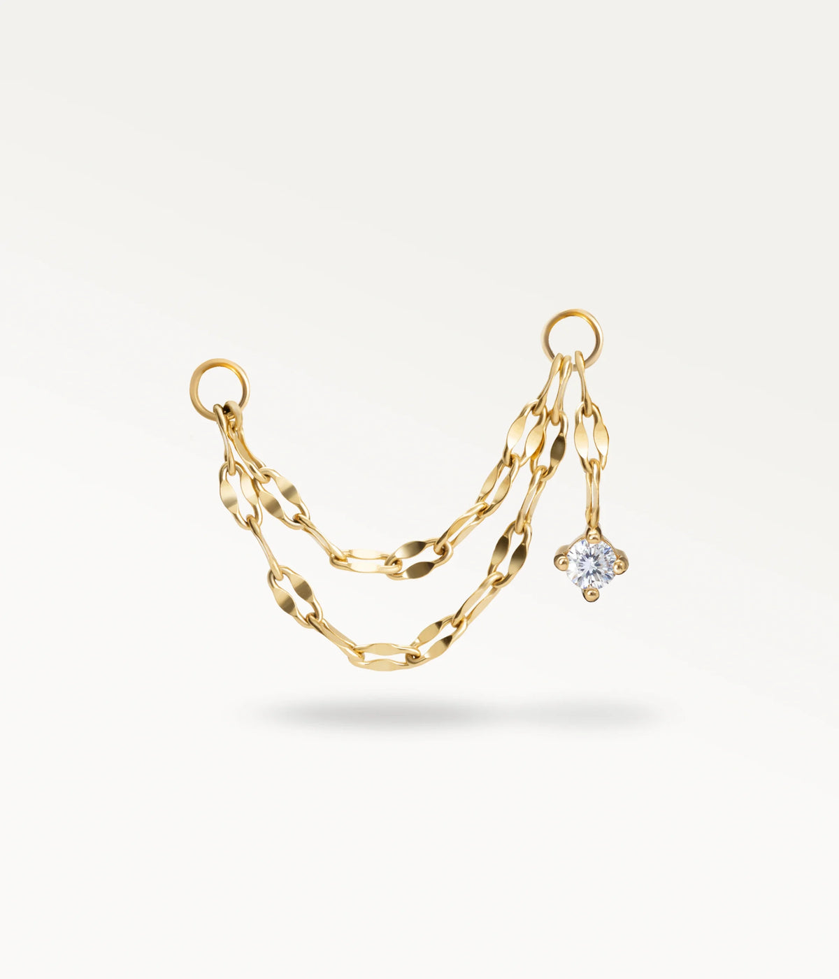 Nuée dorée, double chaîne à maillons plats avec une petite pierre pendante à une extrémité.