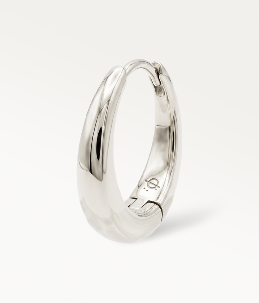 Large silver-tone Soline hoop earring, smooth, domed hoop, three-quarter view.