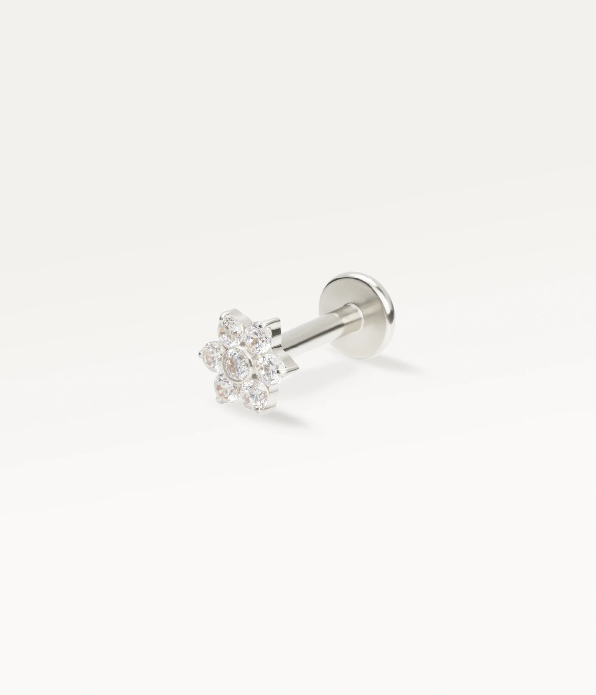 Silver-tone flower piercing jewellery adorned with sparkling zircons, an elegant, refined design