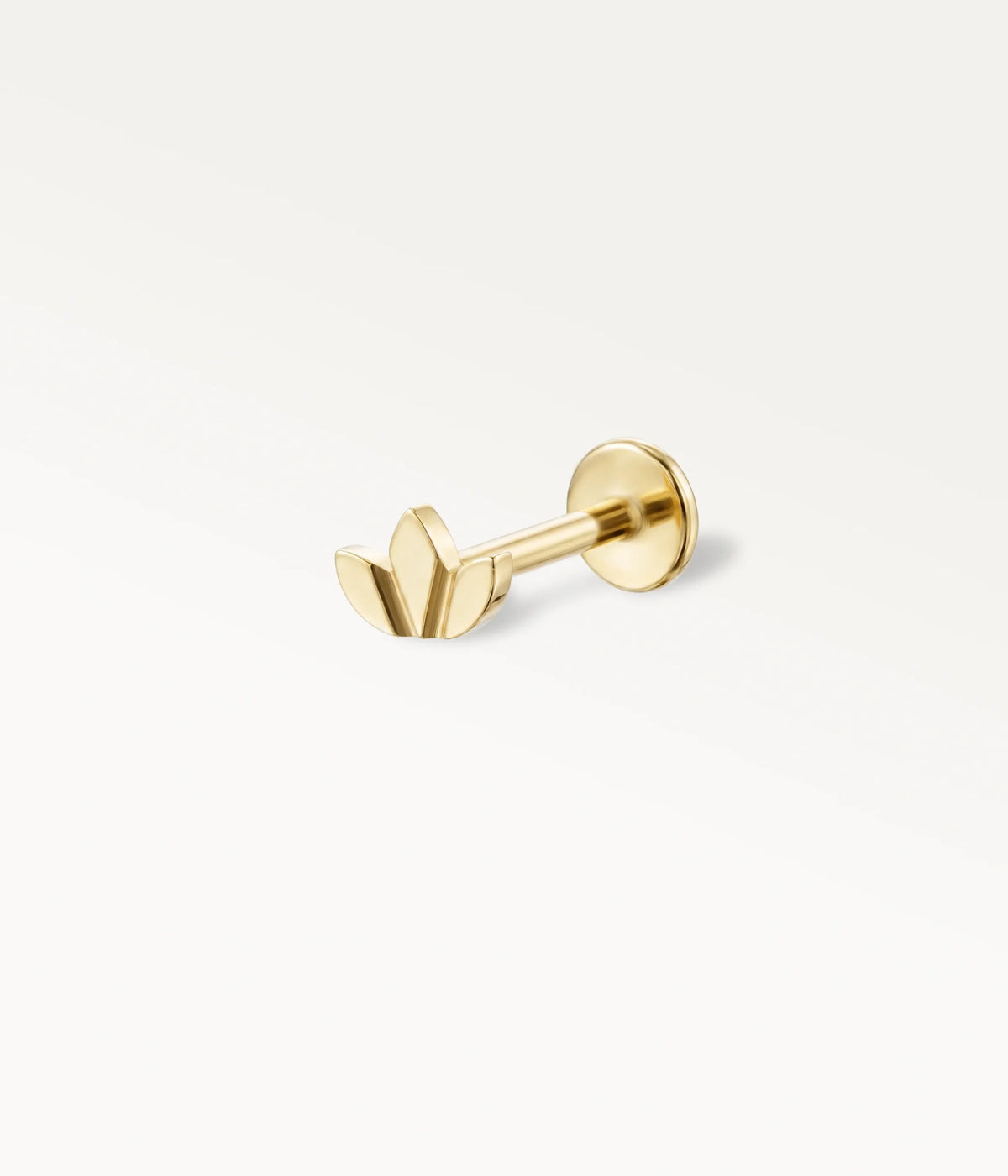 Polished gold-tone lotus flower piercing jewellery, a refined piece of body jewellery in profile view