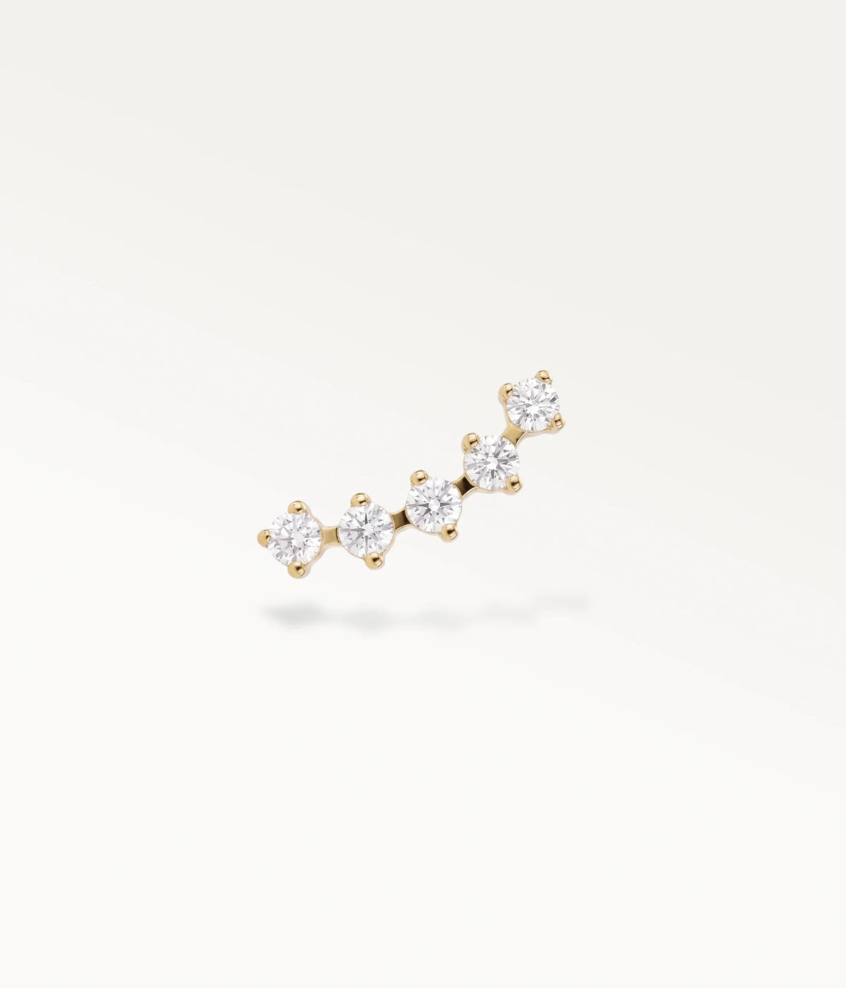 Front view of the gold-tone Sillage helix jewellery, showing the row of 5 sparkling stones against a white background