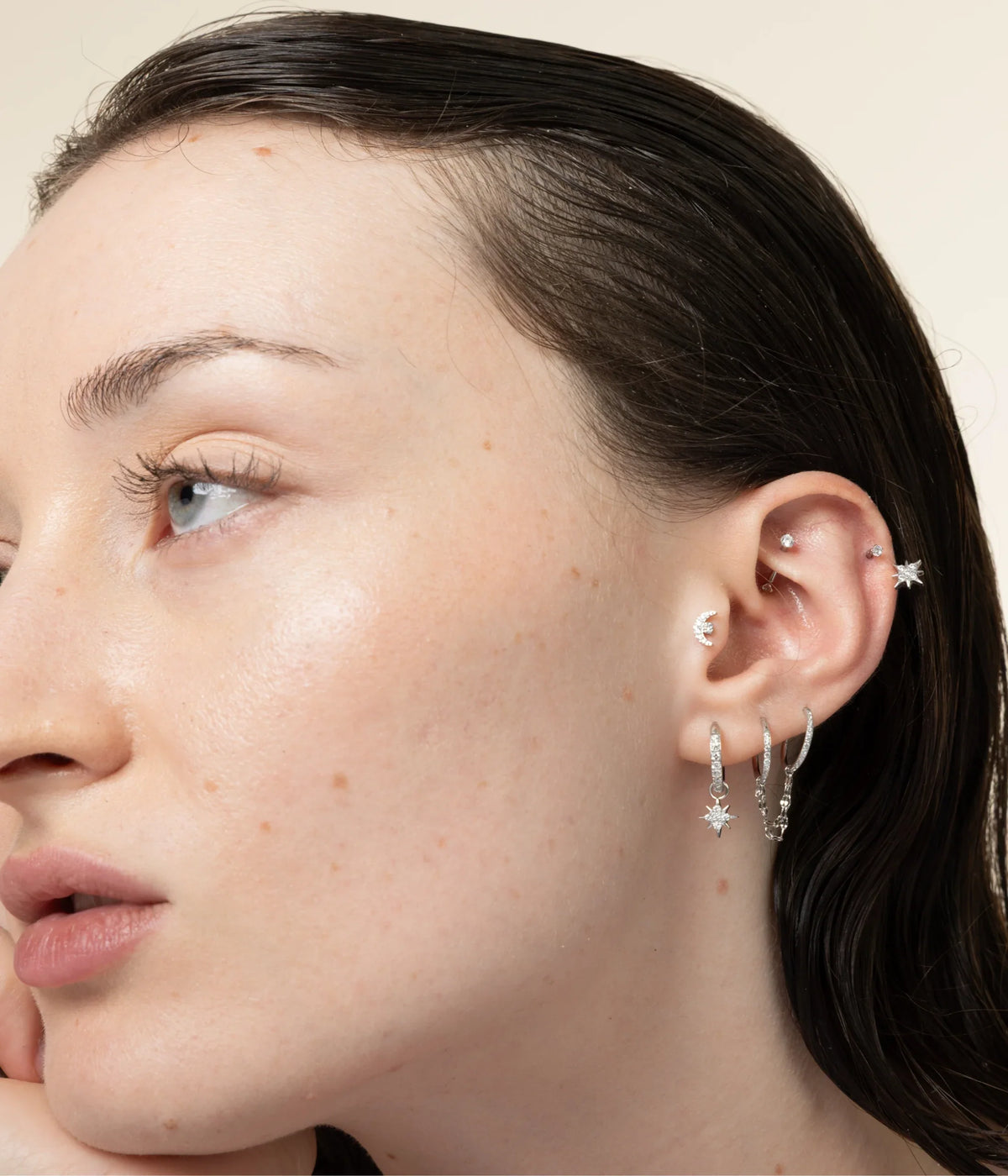 Portrait avec étoile à l’hélix, lune au conch et créoles argentées à pendentifs.