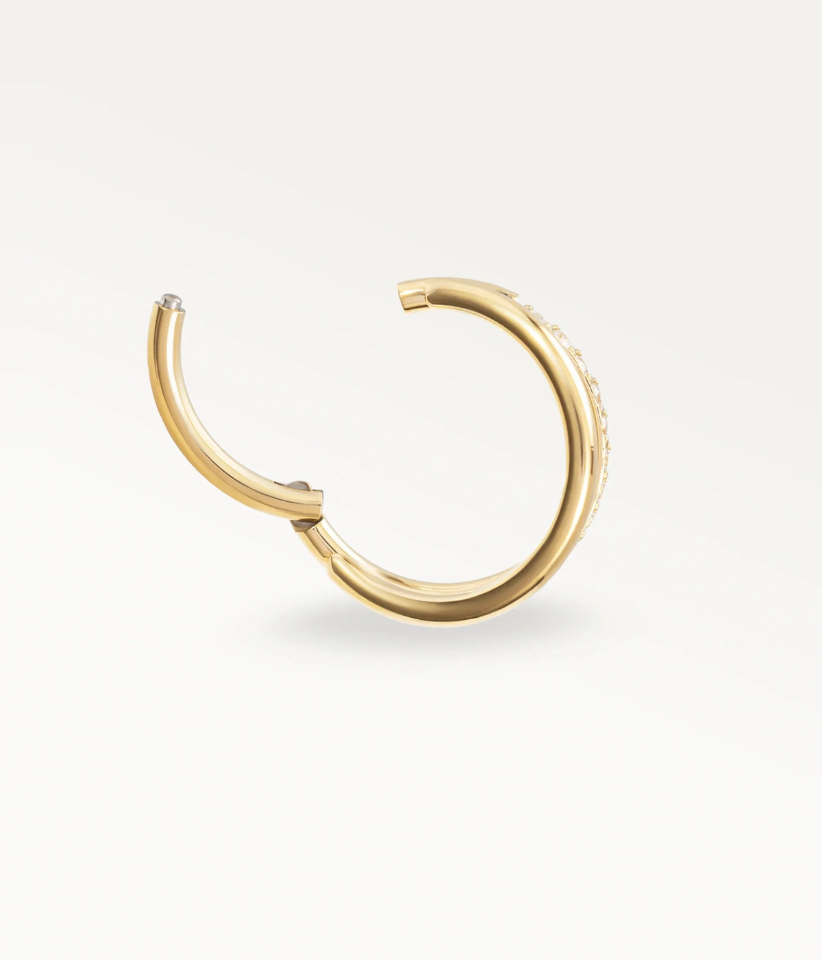 Open gold-tone Mirage hoop showing the hinged fastening.