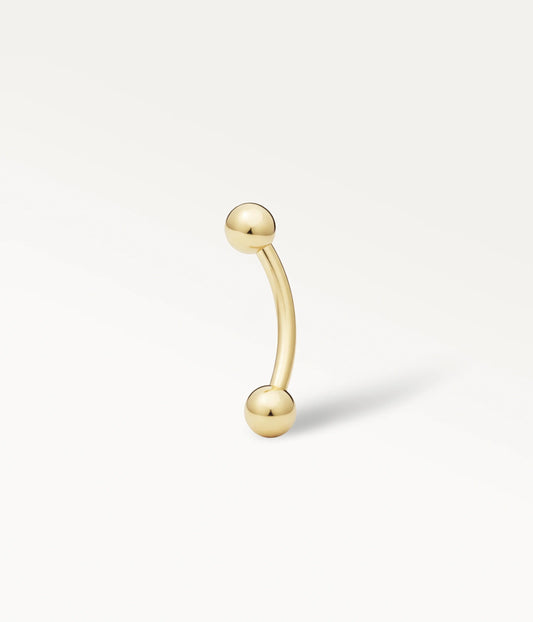 Piercing Bérénice doré, tige courbe terminée par deux billes lisses.