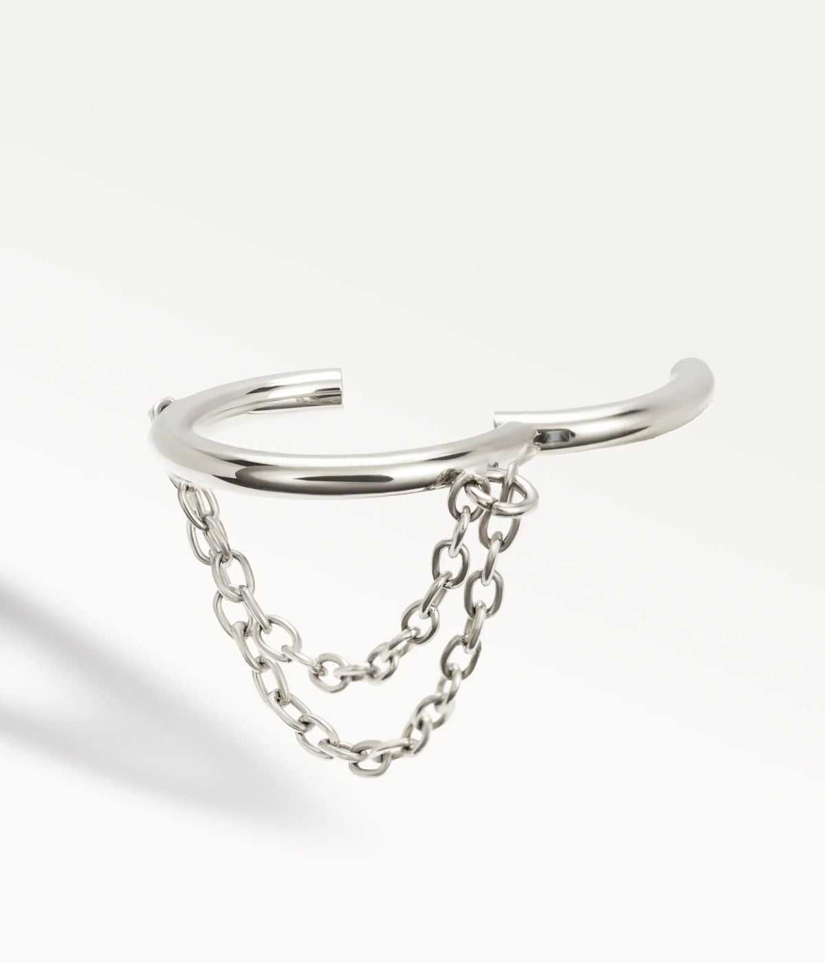 Open silver-tone Élyra hoop, detail of the two chains and hinged fastening.